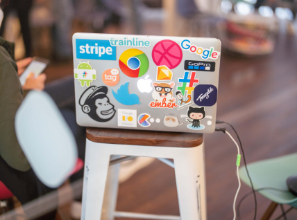 Photo of the back of a pc with many stickers stuck on it